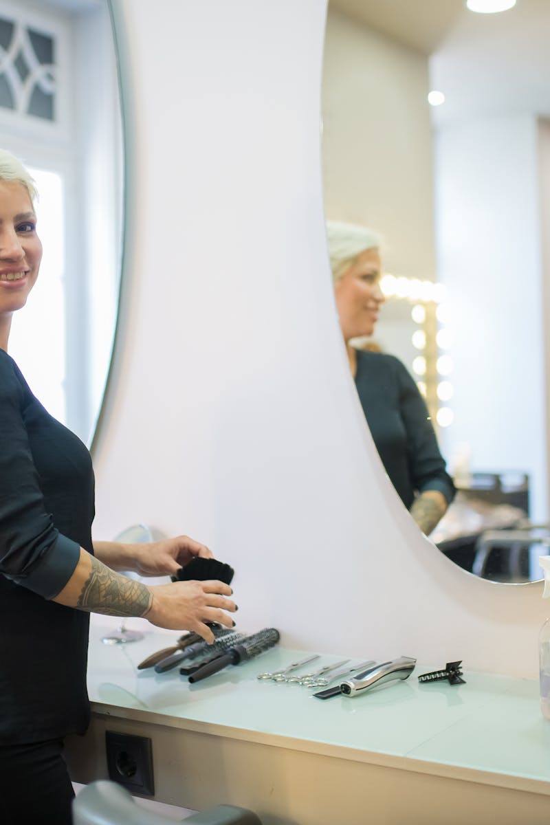 A hair stylist in a modern salon in Portugal with tools and a mirror.